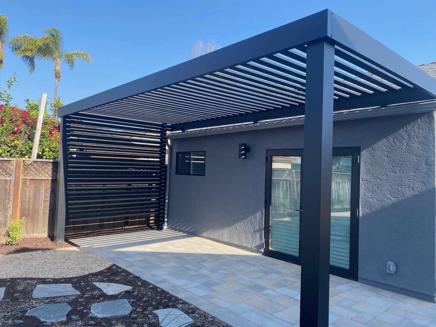 Louvered pergola over a paver patio in Scott by Abshire Brothers Lawn & Landscape