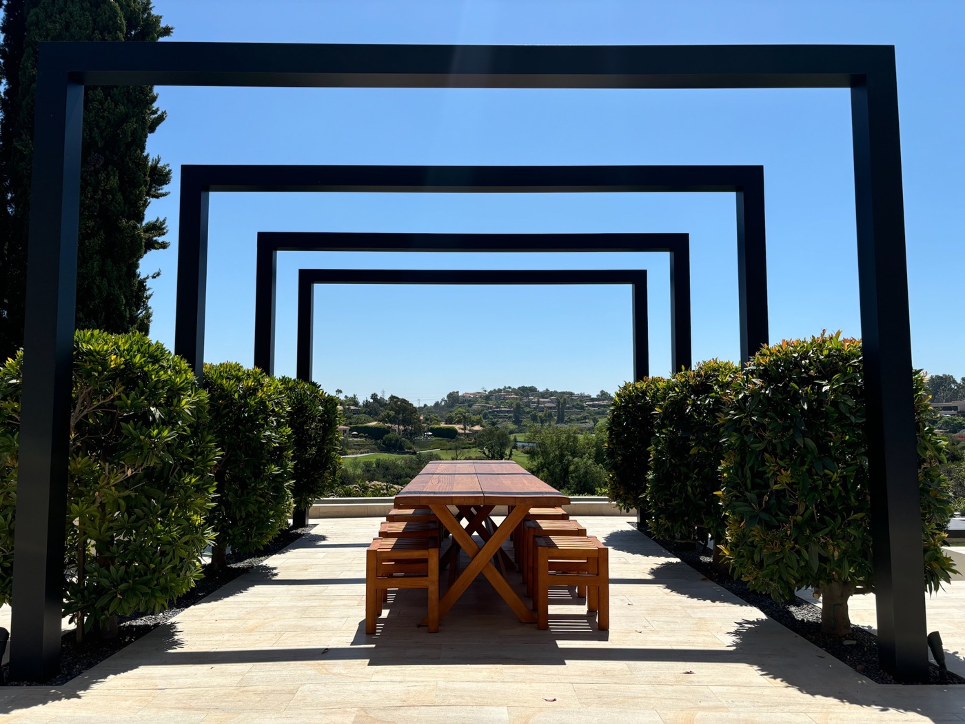 Steel arbor and outdoor dining terrace in Kaplan by Abshire Brothers Lawn & Landscape